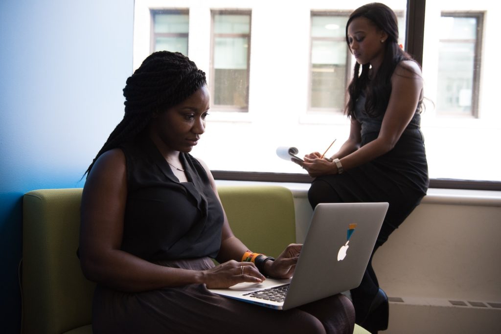 Women researching questions to ask an agent